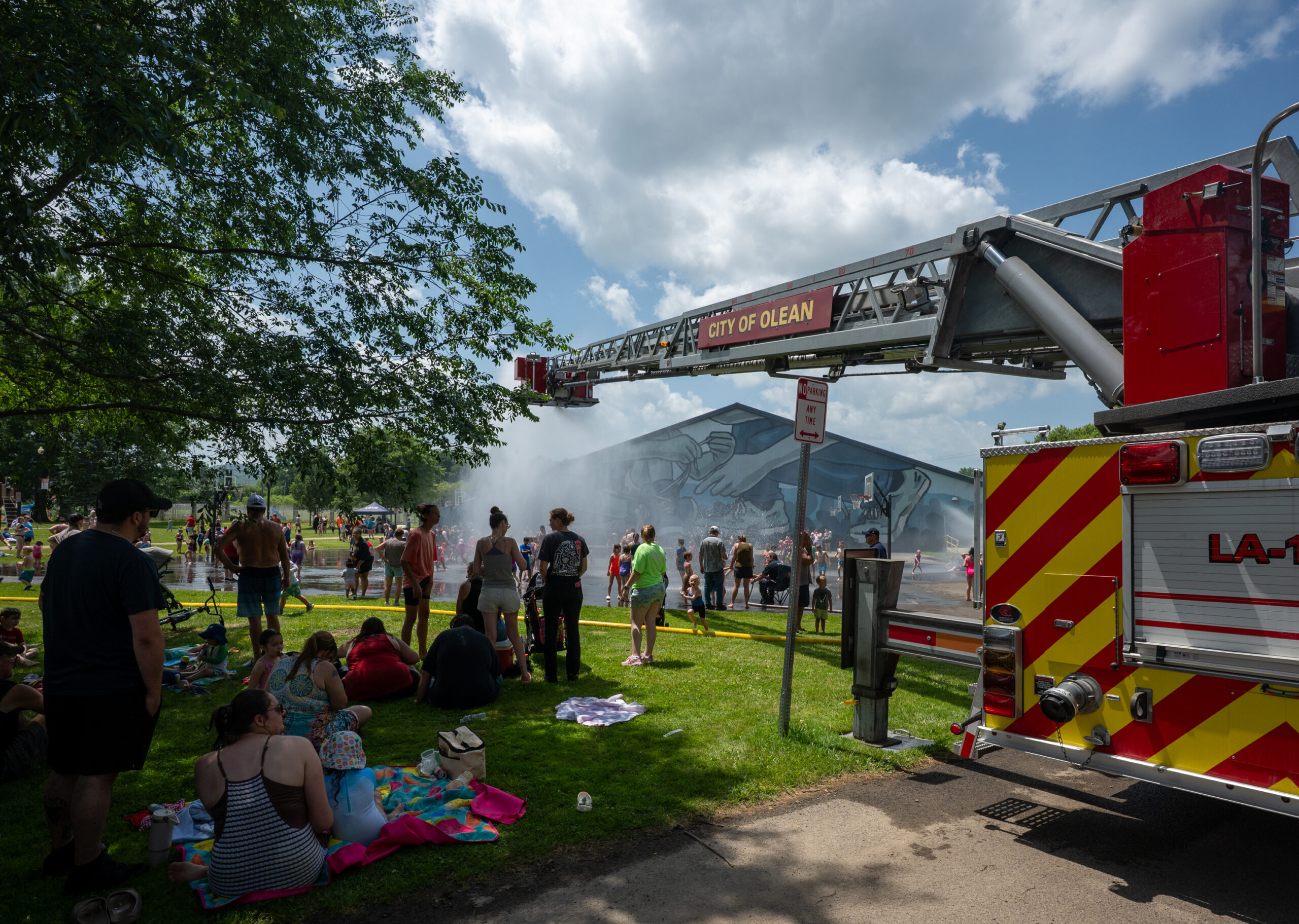 Scenes from fire truck spray at War Vets Park